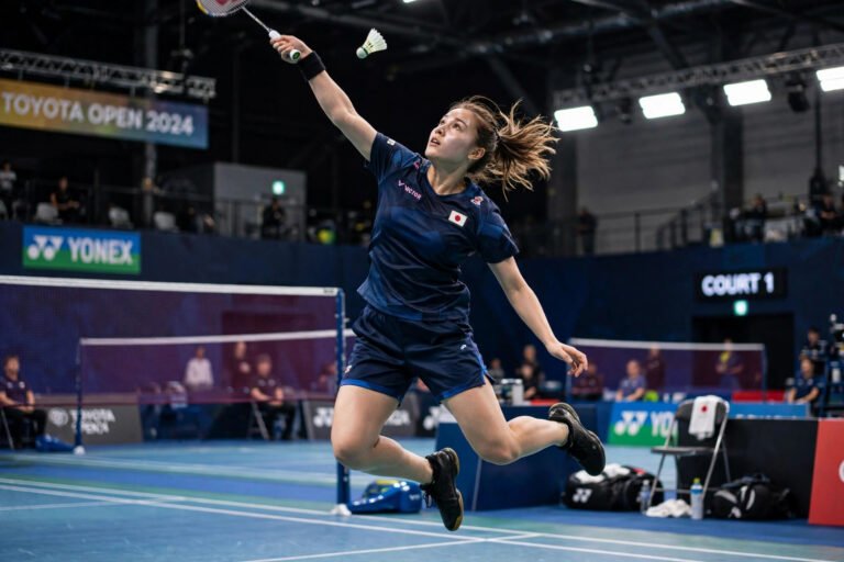 Female badminton player executing powerful smash
