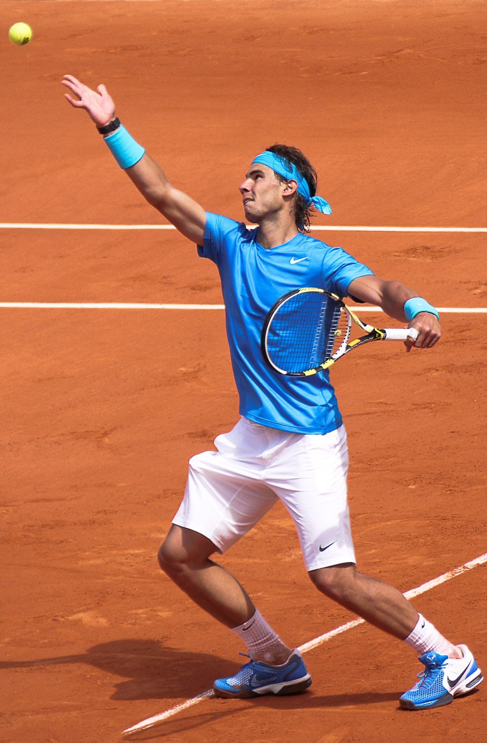 Professional player hitting a forehand on a clay court at Roland Garros
