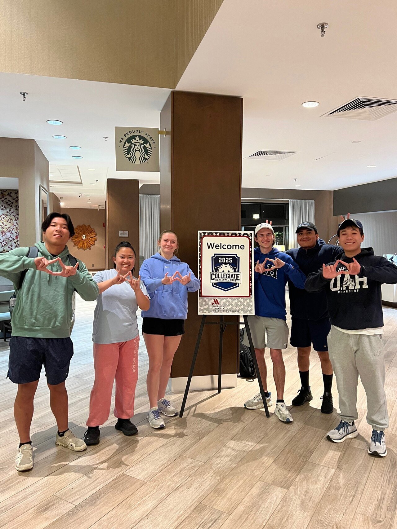 Collegiate pickleball players competing indoors at a national championship event