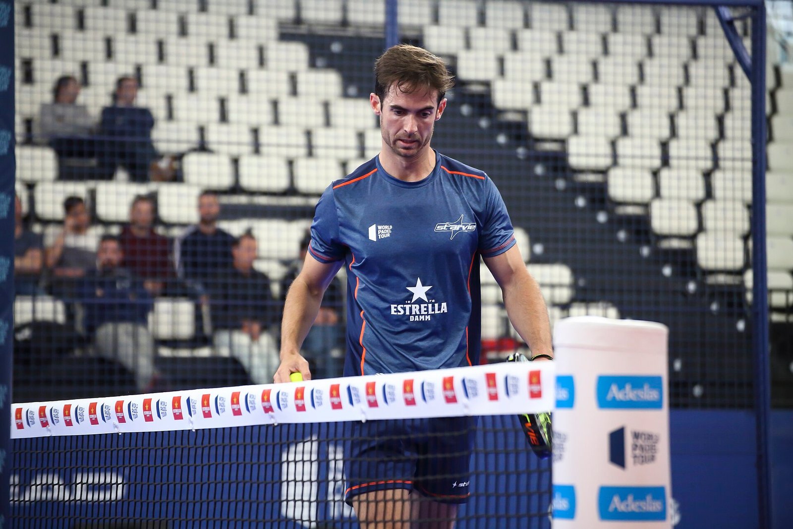 Professional padel players contesting a rally during a World Padel Tour event in Vigo
