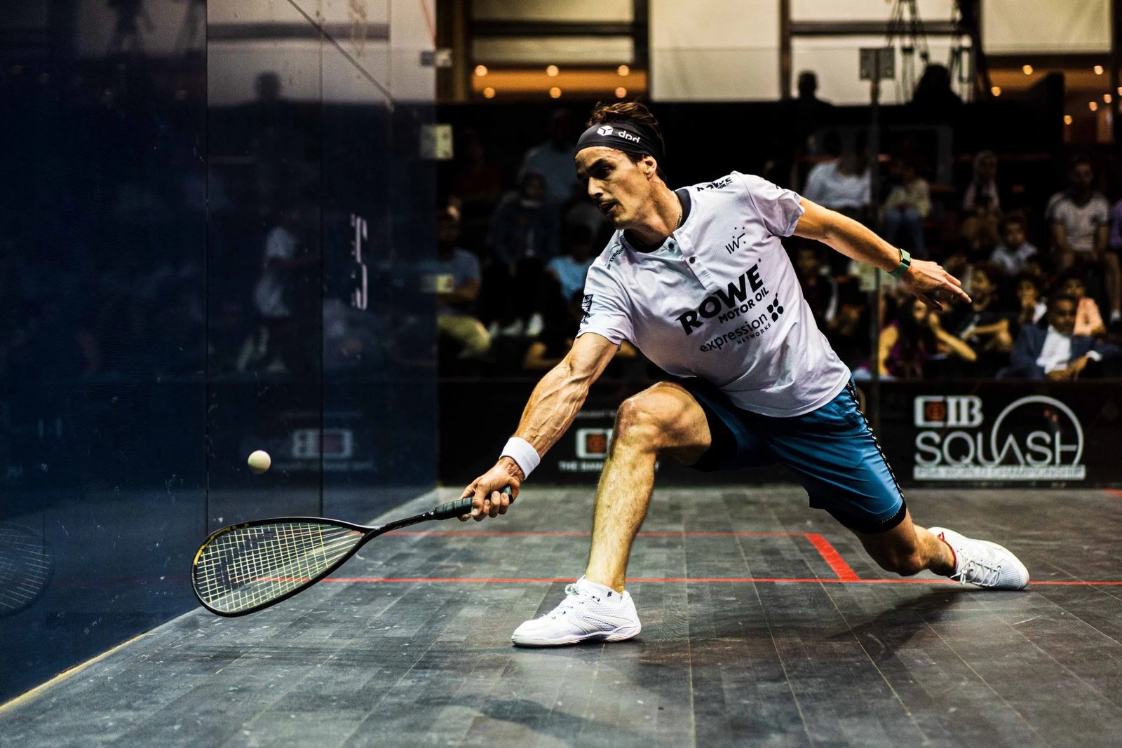 Paul Coll in full stretch during a professional squash match
