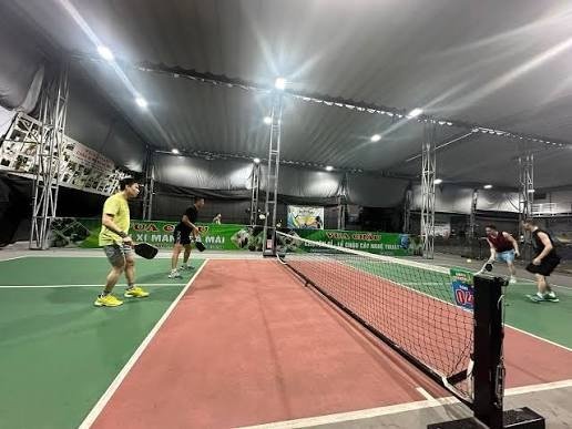 A pickleball game in progress on an indoor court