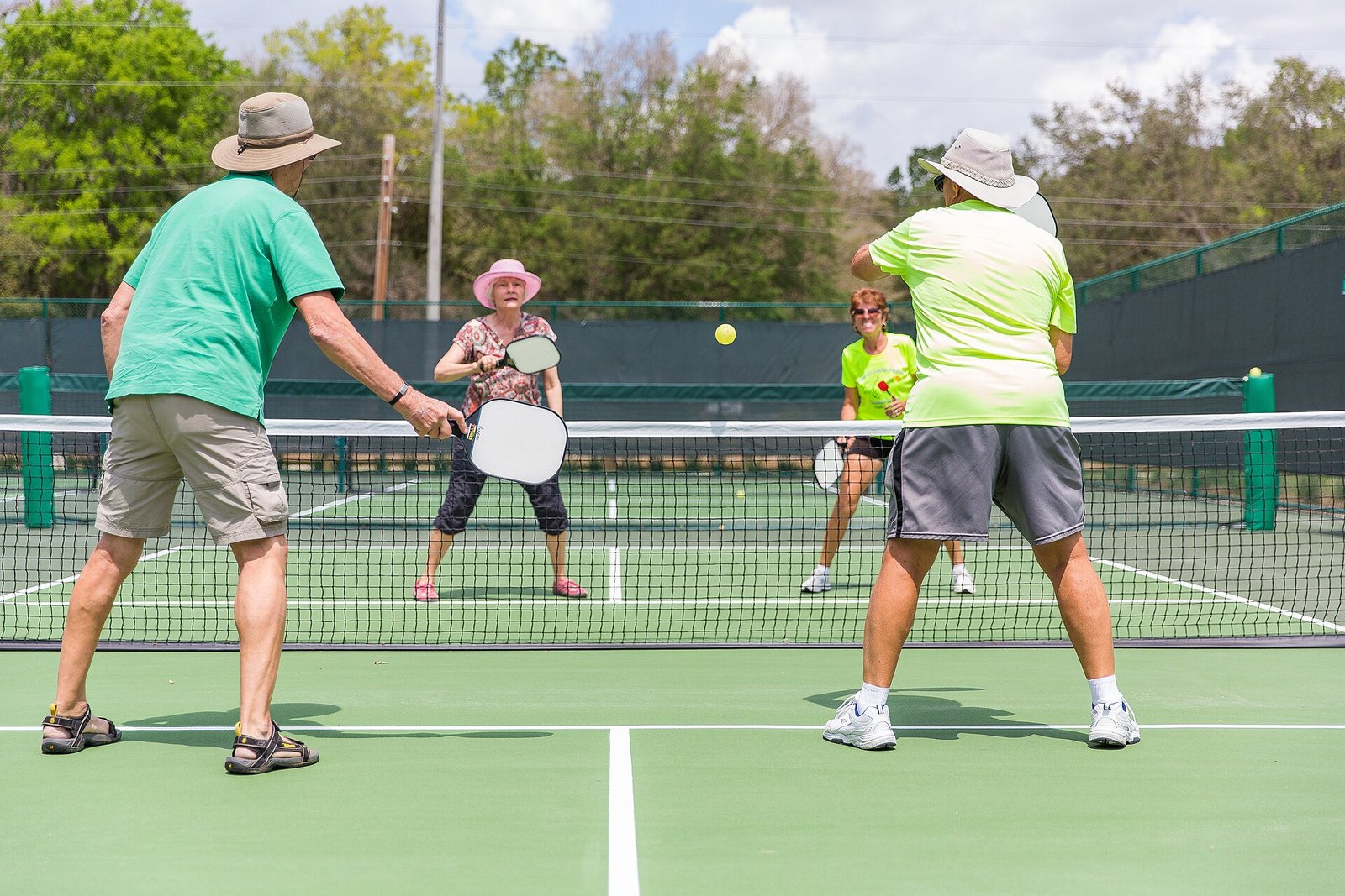 Pickleball doubles players positioned at the kitchen line during a match