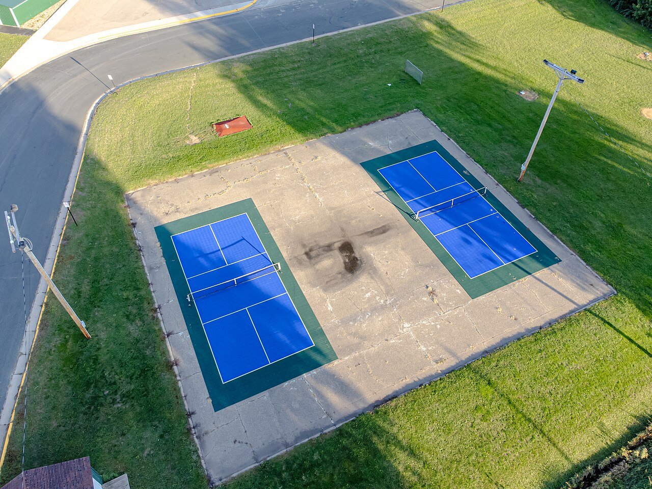 Outdoor pickleball courts with nets set up for recreational play