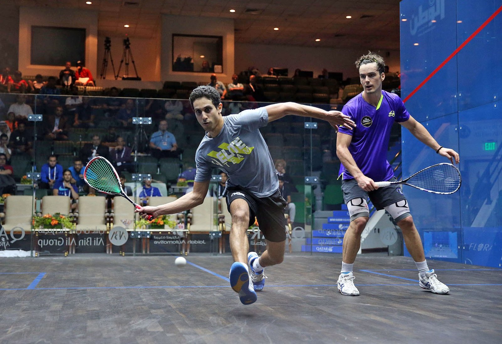 Professional squash players contesting a rally on the PSA World Tour