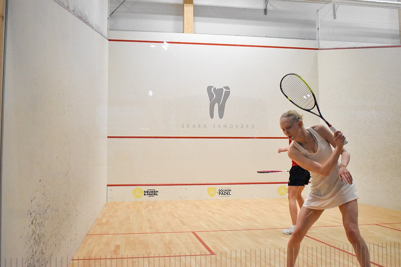 Two squash players contesting a rally during a competitive match