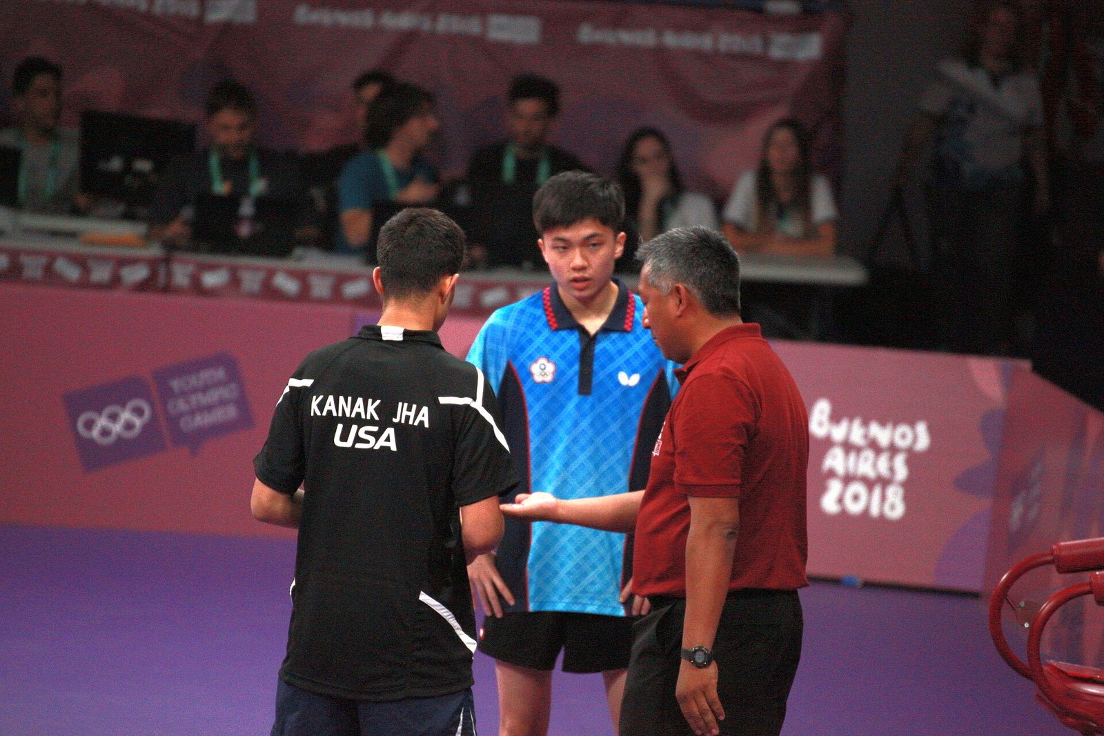 Table tennis players competing in a singles bronze medal match
