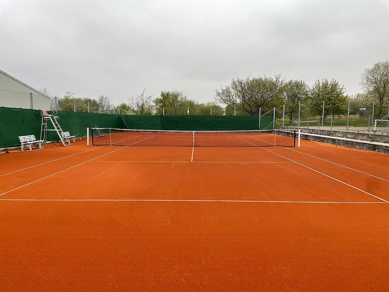 Outdoor clay tennis courts at a local club, the surface that calls for a full herringbone clay-court outsole
