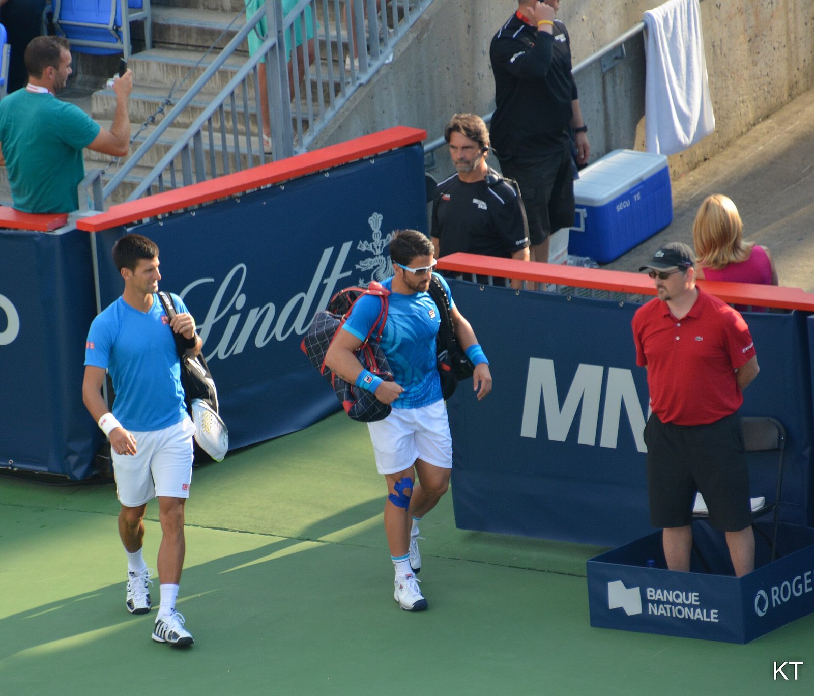 Tennis doubles players in action during a match