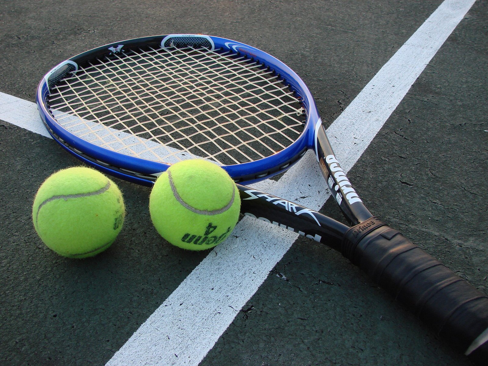 Tennis racket and balls — the kit a tennis bag has to organise