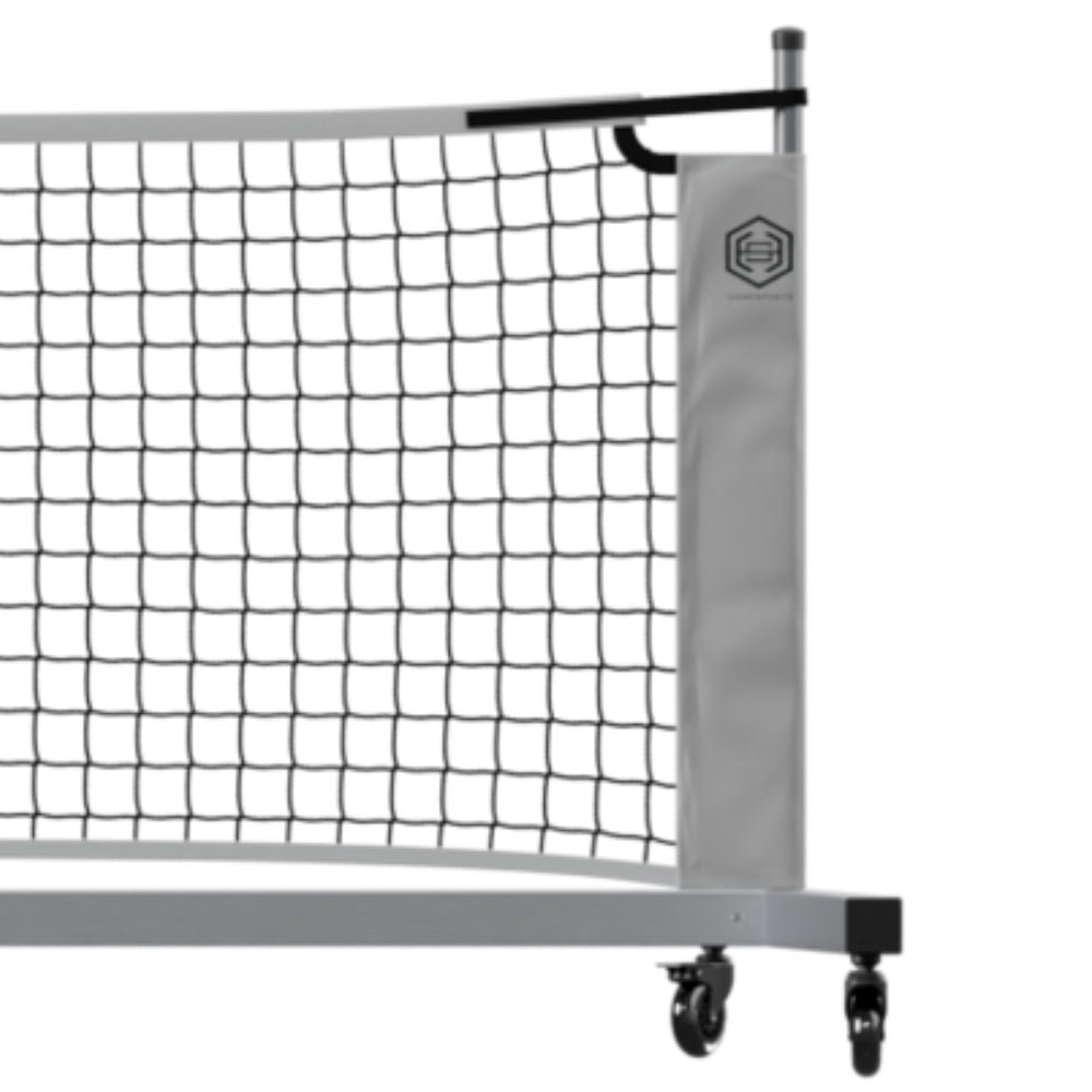 Close-up of a wheeled pickleball net frame showing the post, net edge and locking caster wheels