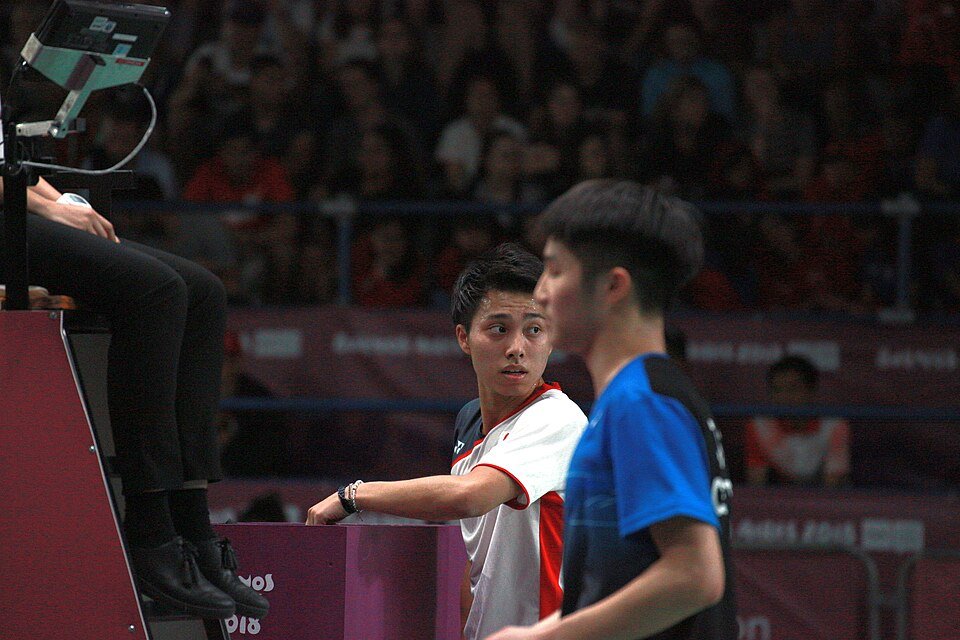 Junior players competing in a badminton match at the Youth Olympics