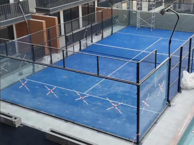 Newly installed panoramic padel court in the UAE with the protective film crosses still on its glass panels
