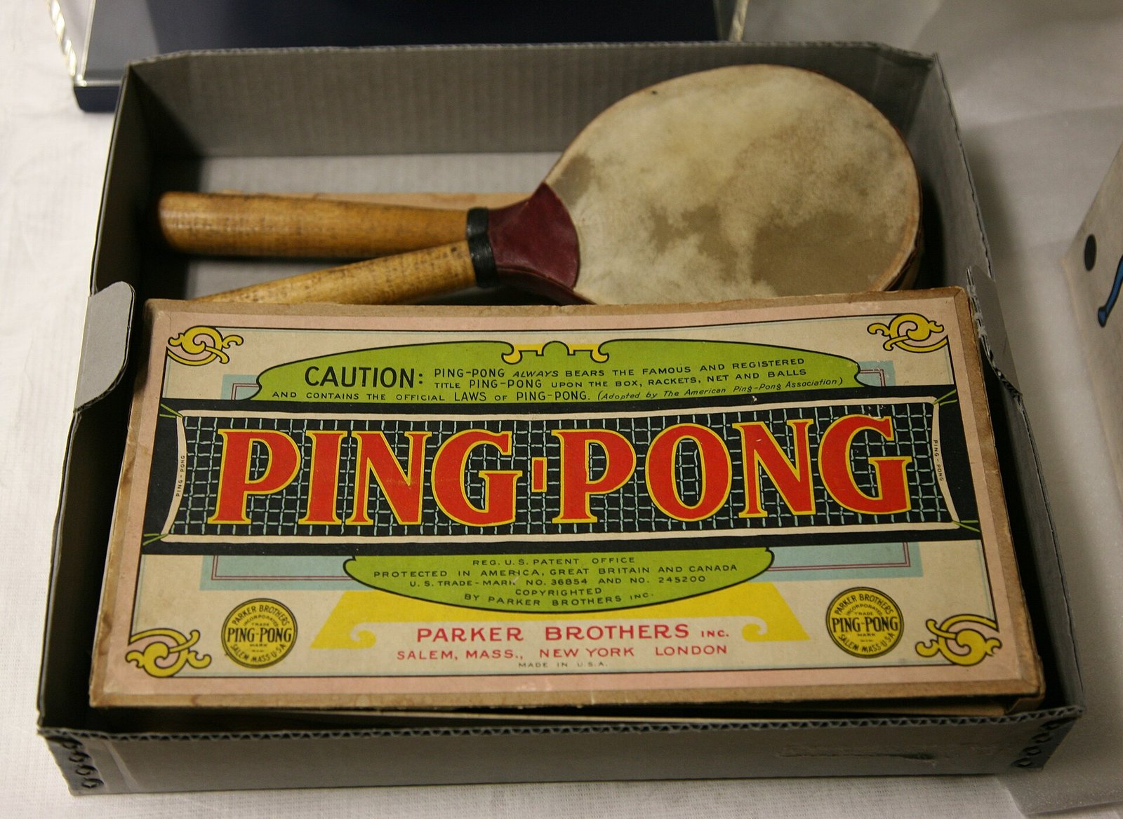 Vintage Parker Brothers Ping-Pong game set in its box, the lid printed with a warning that Ping-Pong is a registered title