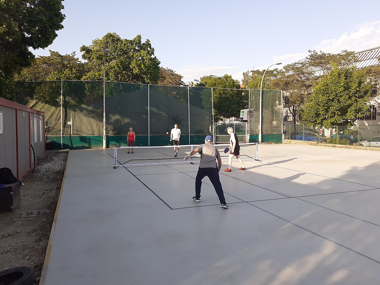 Pickleball players practising shots during a coached training session